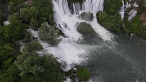 Top-view-of-water-flowing-through-trees-at-Kravica-waterfall-in-Bosnia,-travel-attraction,-summer-tourism-concept