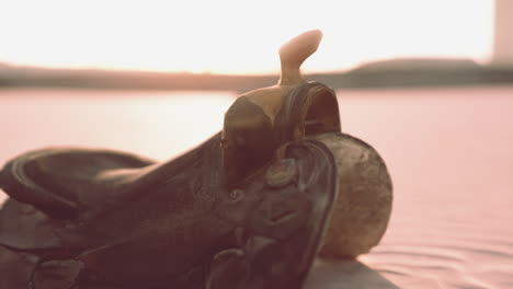 old horse saddle on the beach