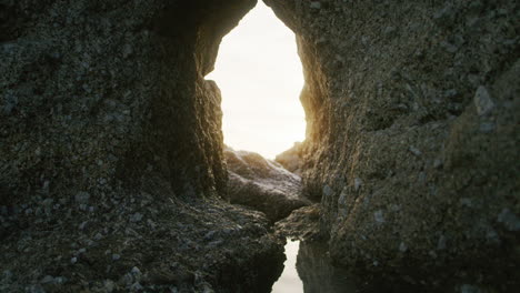 rocky passage on the coastline at sunset with sun in shot 4k prores 422