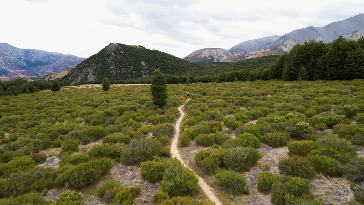 Drone following a person MTB biking in the wilderness of Cragieburn, New Zealand