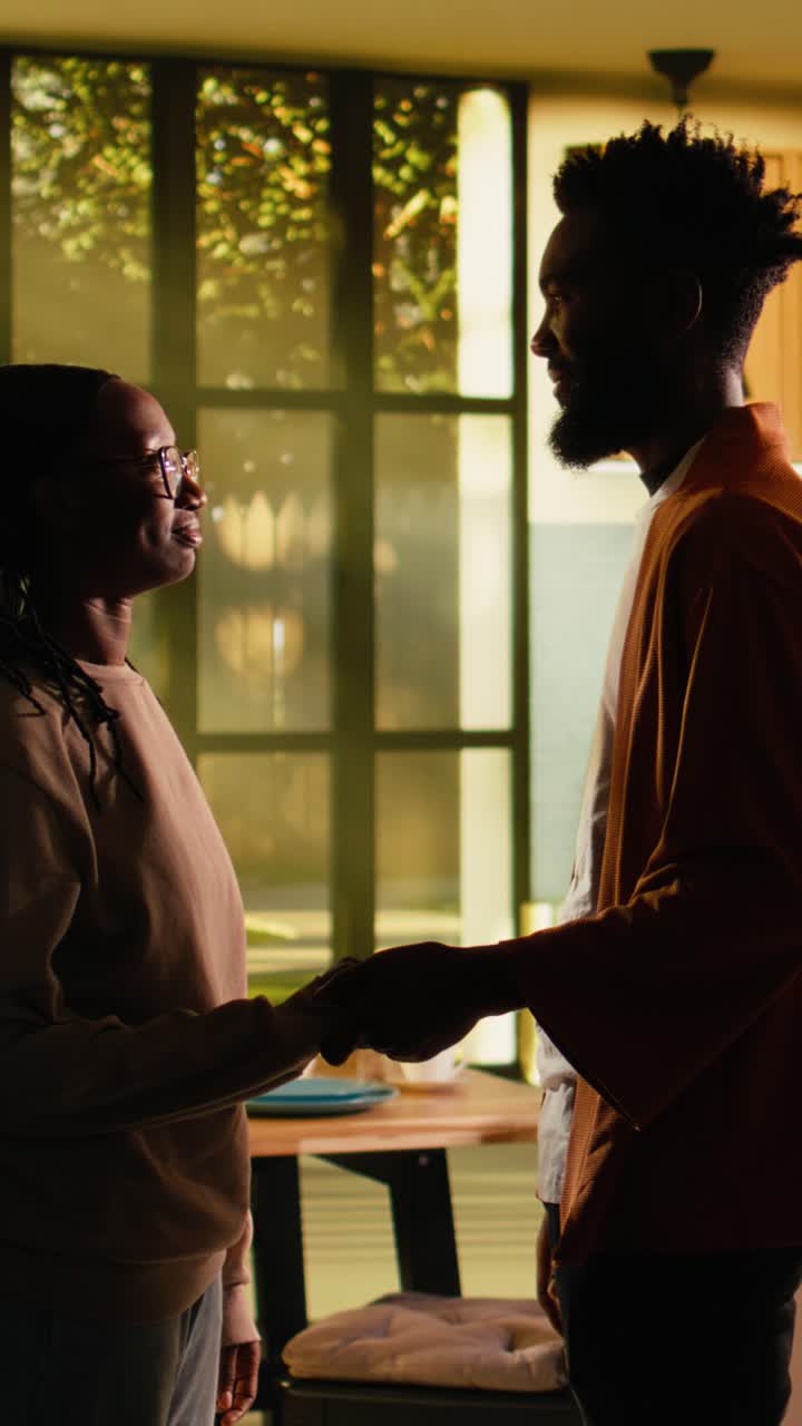 Vertical Video Loving black couple holding hands after fight, enjoying calm reconciliation