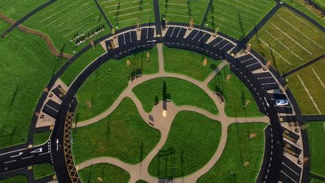 modern circular cemetery pathway design aerial view artistic garden of rest descending tilt up