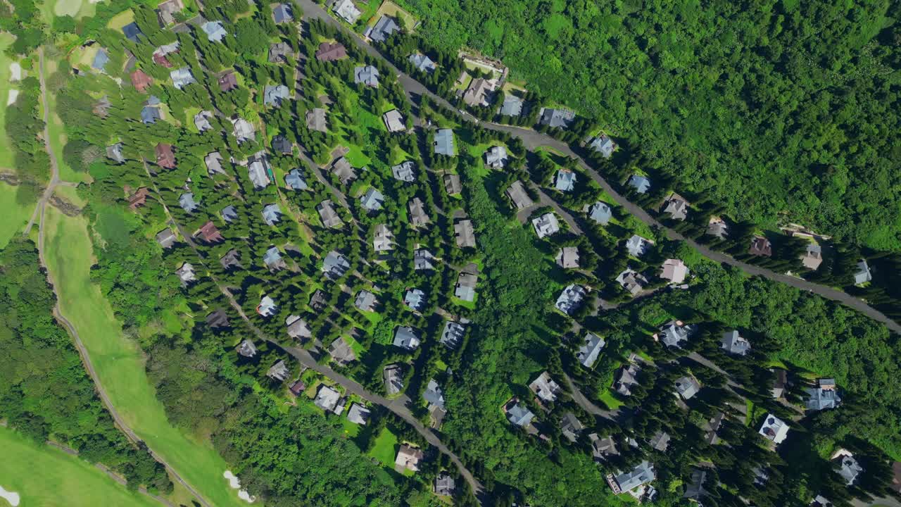 A rotating top view of The Woodlands Tagaytay Highlands with cinematic lighting over pine trees in Batangas, Philippines