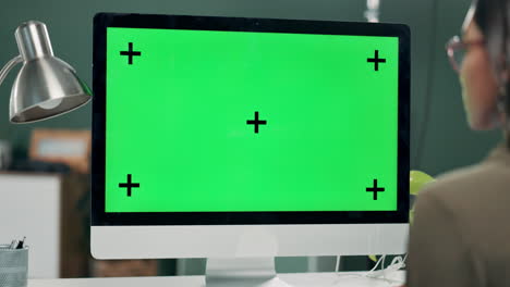 computer with green screen and woman in office