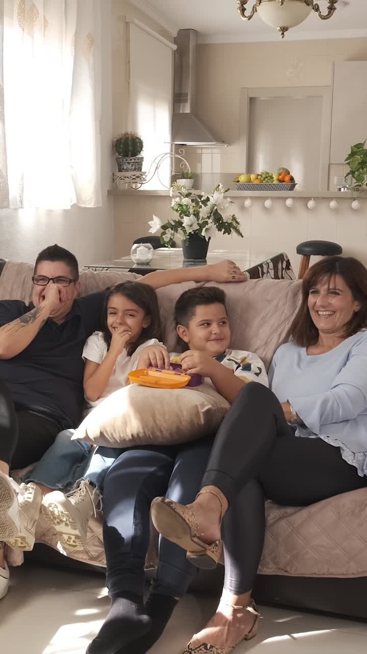 Non-normative family watching television together at home