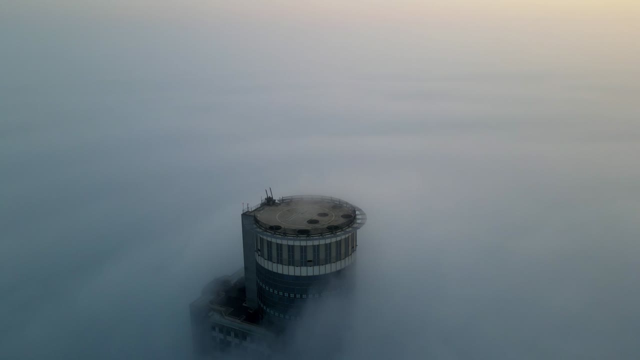 Tower Piercing Through Foggy Sunrise/Sunset