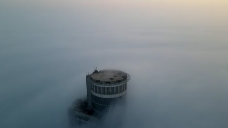tower piercing through foggy sunrise/sunset