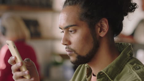 Retrato-De-Un-Hombre-Guapo-De-Raza-Mixta-Usando-Un-Teléfono-Inteligente-En-Una-Cafetería-Bebiendo-Café-Enviando-Mensajes-De-Texto-En-Línea-Leyendo-Mensajes-De-Redes-Sociales-En-Un-Teléfono-Móvil-Disfrutando-De-Un-Relajante-Estilo-De-Vida-En-Un-Restaurante