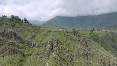 drone shot showing the beginning of the trekking path from cabanaconde, offering a panoramic view of the colca canyon and the winding trail leading towards sangalle.