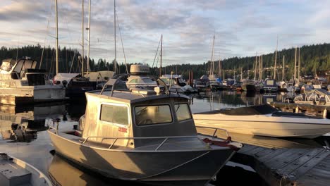 moored boats at deep cove marina, vancouver, on water, panning shot