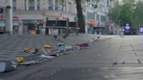 medium close-up of trash on the ground in central cardiff after a friday night