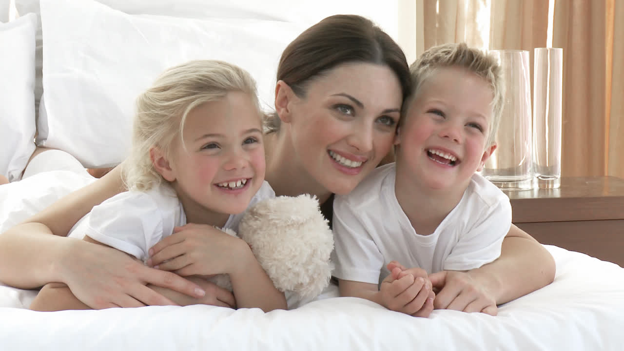Mother, daughter and son together in bed