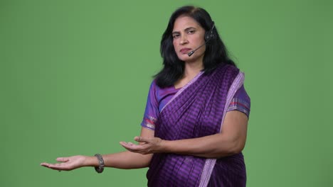 mature beautiful indian woman as call center representative showing something