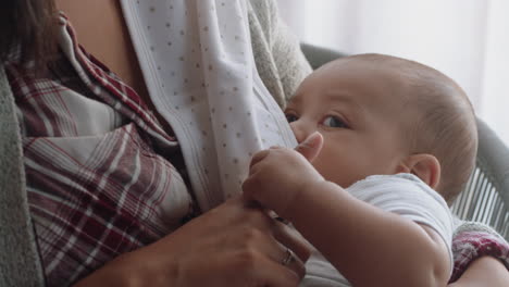 young mother breastfeeding baby at home nursing infant enjoying motherhood