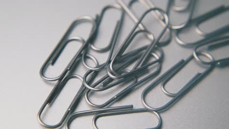 pile of paperclips for school and office on grey background