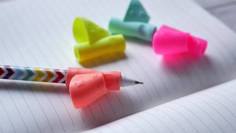 colorful pen and grip aids on notepad