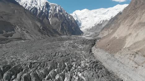 aerial over hopar glacier in nagar valley with snow capped mountains