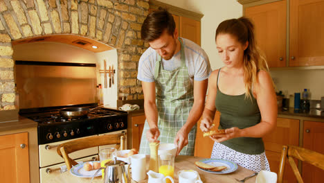 couple preparing breakfast in kitchen at home 4k