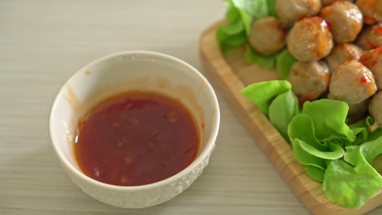 grilled meatballs skewer with spicy dipping sauce