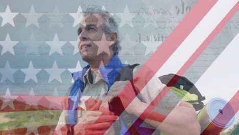 animation of american flag over senior caucasian man hiking in mountains