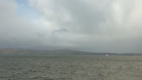 hand-held shot of the scottish landscape from a ferry on a overcast day