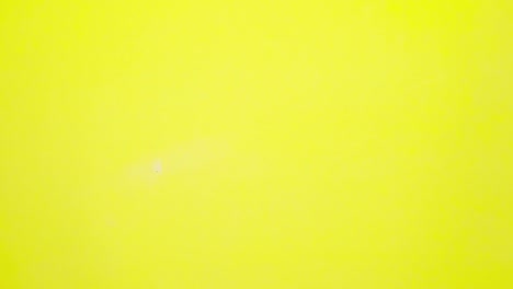 stop motion animation of red headphone on light yellow paper background flat lay minimal top view seamless loop video time lapse