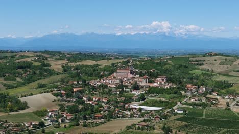 small town of piedmont in italy with alps mountain range in background