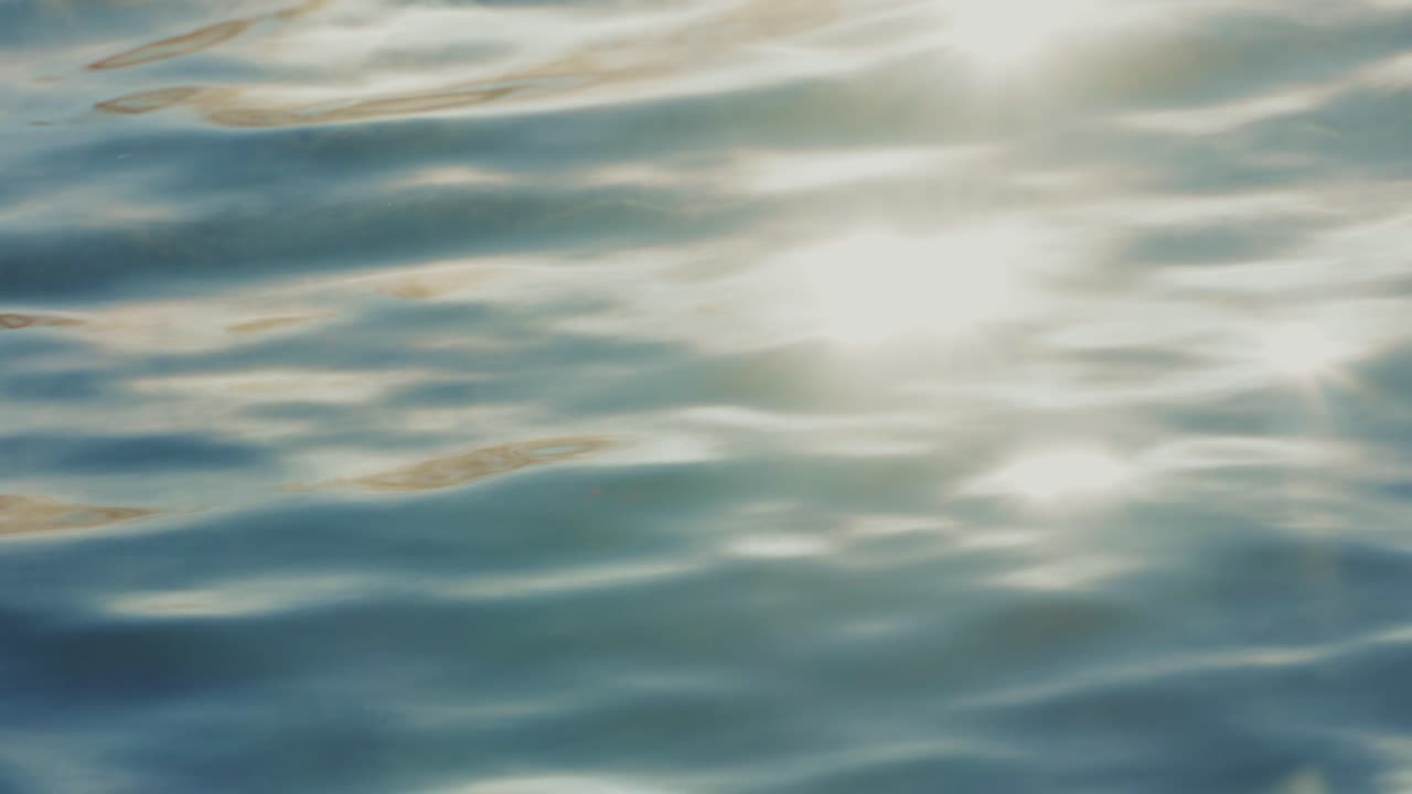 Sunlight reflecting on rippled water surface
