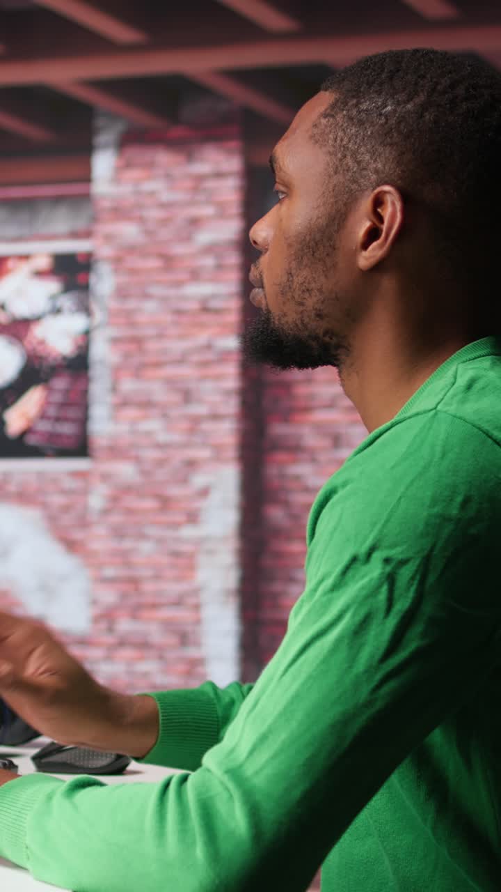 Vertical Video Black graphic designer working in loft with AI image generator