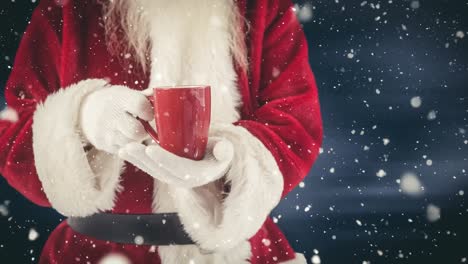 Santa-clause-holding-a-hot-drink-combined-with-falling-snow