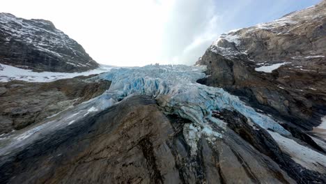 flight across glacier in the mountains