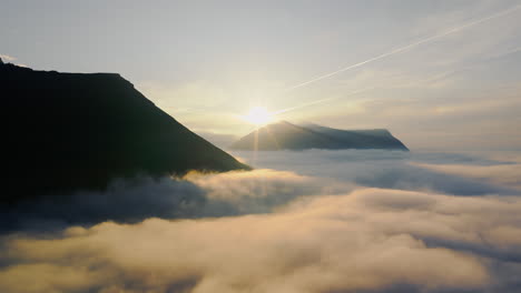 Sunrise over misty mountains above the clouds