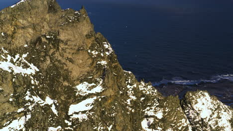 drone shot circling a rocky mountain ridge, golden hour on the coast of iceland