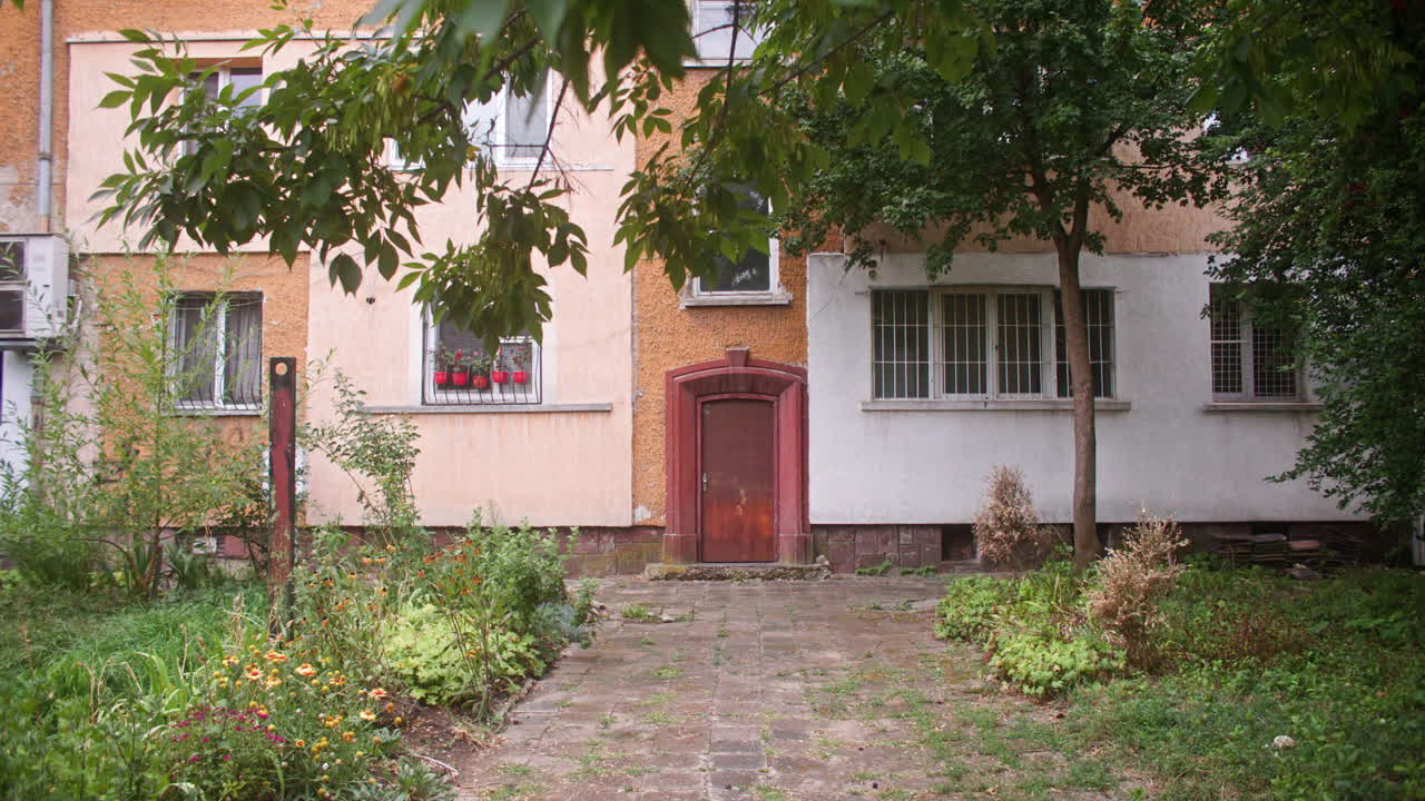 A neighborhood with communist architecture apartment buildings and the surrounding neighborhood environment, parks and trees from the communist era on the Balkans in Sofia, Bulgaria, Eastern Europe