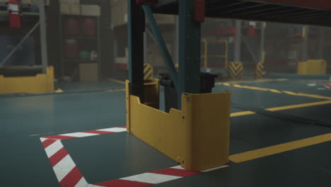 close up of yellow safety barrier on warehouse floor