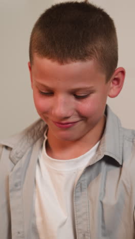 schoolboy looks at bags with food. mother lays out shopping. hungry son takes cookies from mom smiling contentedly on blurred background closeup