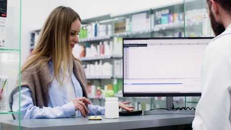 young woman buying at the pharmacy