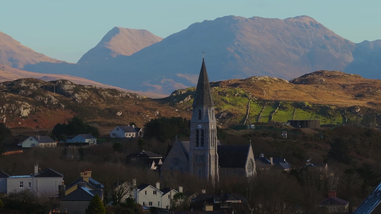 4K Aerial drone footage of St Joseph’s Church in Clifden, Galway with Connemara Mountains Background_004
