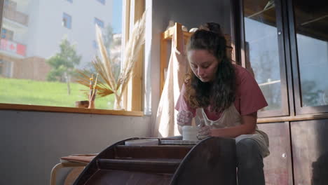mujer creando cerámica en una rueda