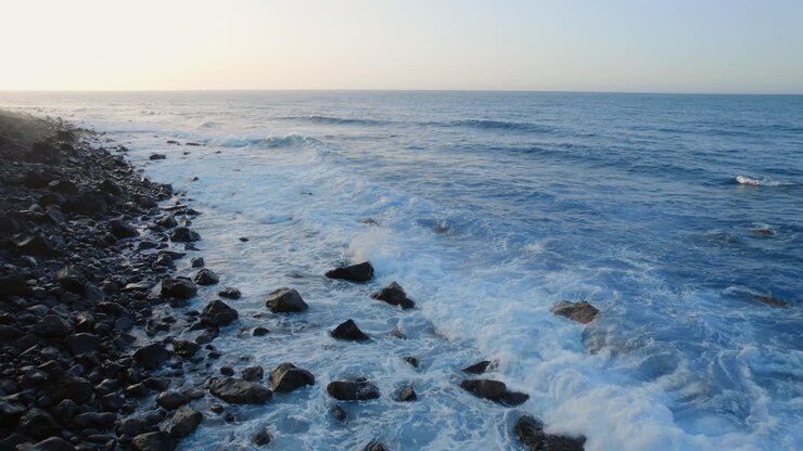 Ocean waves crashing on a volcanic rocky shore