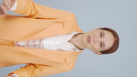 Vertical-video-of-Business-woman-happily-speaking-to-camera.