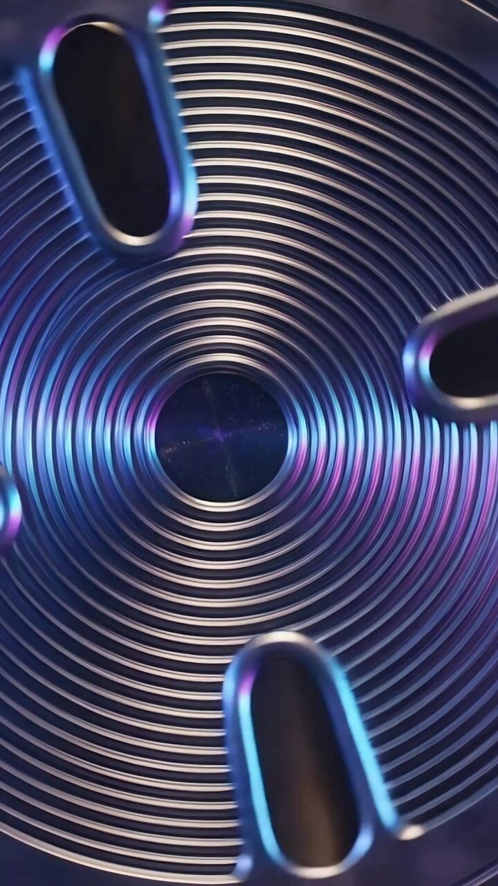 Vertical video: Camera shifting causing machined metal disc rotating at workbench revealing grooves