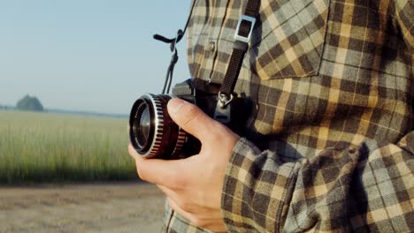 man with vintage camera in a field