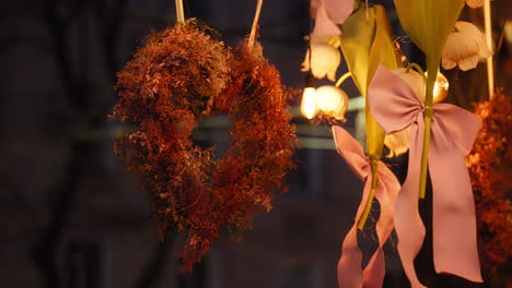 Slow-motion-close-up-of-decorative-object-with-heart-shape-made-with-dry-leaves-hanging-in-shop