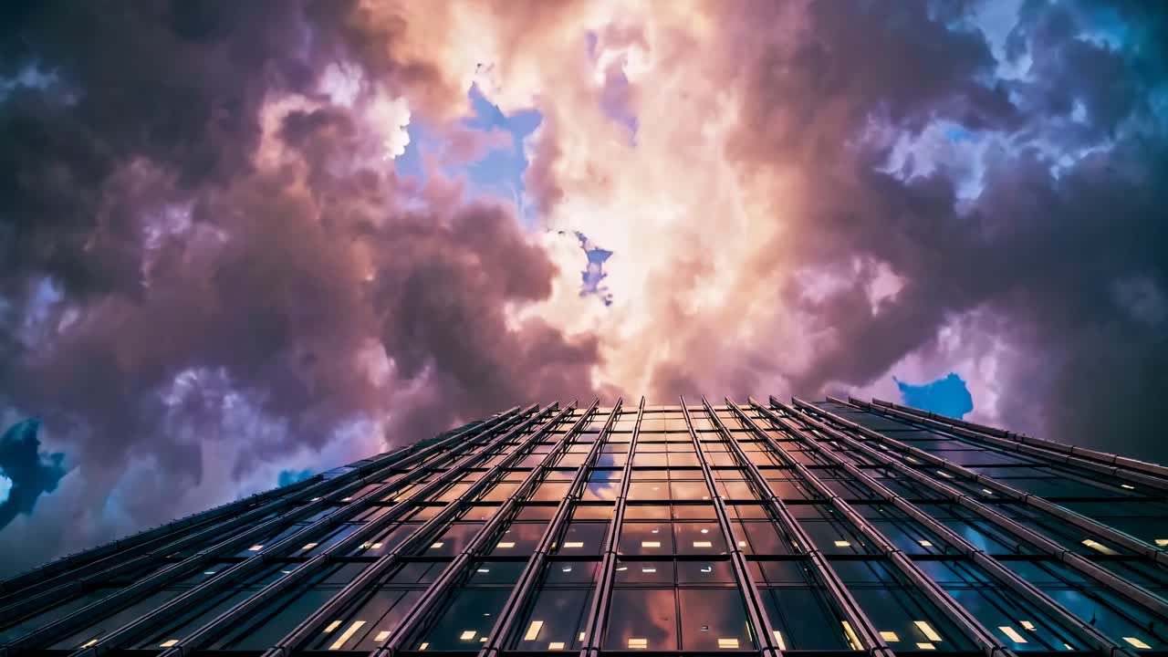 Video showcasing a modern glass building against a dramatic sky, emphasizing architectural design