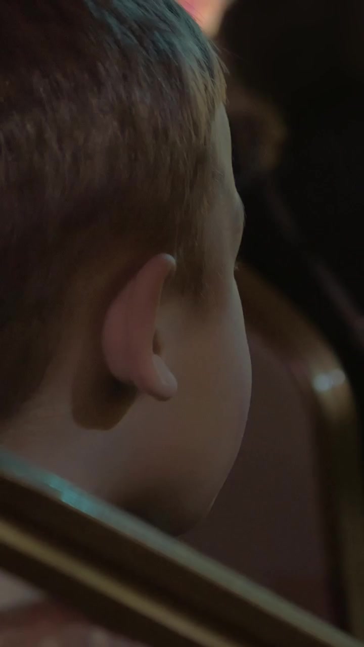 Boy watching theatrical performance and applauding