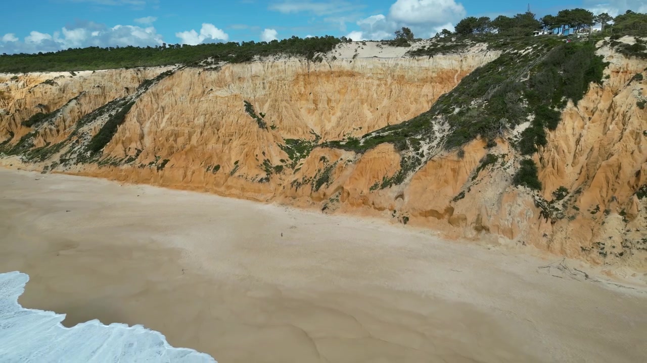 Riprese aeree con drone di Praia do Pinheirinho, Portogallo: costa atlantica selvaggia, spiaggia sabbiosa e scogliere aspre sotto luce naturale. Ideale per progetti di viaggio, estivi e paesaggistici