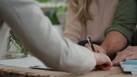 close-up-hands-signing-mortgage-lease-agreement-couple-meeting-real-estate-agent-buying-house-new-home-owners-purchasing-property-shaking-hands-with-realtor-enjoying-investment