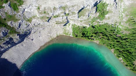 Aerial-Top-Down-Blue-Green-Water-Carnarvon-Lake,-Kananaskis,-Alberta,-Canada