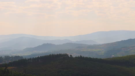 northern portuguese mountains showcasing a parallax effect with overlapping layers under a hazy sky